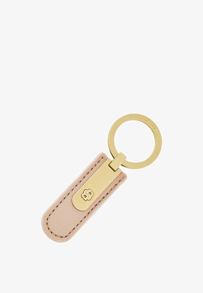 Porte-clés en cuir beige texturé avec attache métallique dorée et anneau gravé "BOSS", présentant un design minimaliste et des bords cousus.