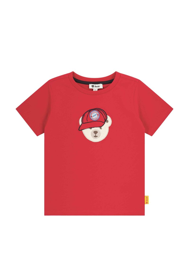 Red cotton t-shirt featuring an embroidered bear head with a cap, displaying a logo. Short sleeves and a crew neck design. Yellow tag on the side.