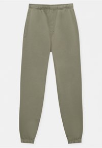 Pantalones deportivos verdes hechos de tela suave, con cintura elástica, bolsillos laterales y puños ajustados en los tobillos.