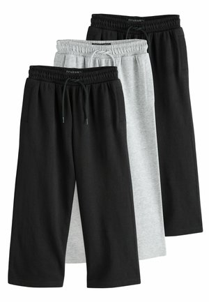 Trois pantalons de survêtement décontractés à cordon de serrage, en noir et gris clair, disposés de manière superposée sur un fond blanc.