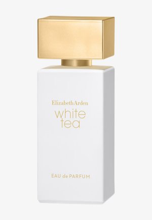 Flacon de parfum rectangulaire blanc avec bouchon carré doré, étiqueté "Elizabeth Arden white tea EAU de PARFUM" en lettres dorées sur le devant.