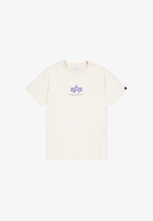 Krémové tričko vyrobené z měkké bavlny, s fialovým logem s geometrickými tvary na hrudi a krátkými rukávy.