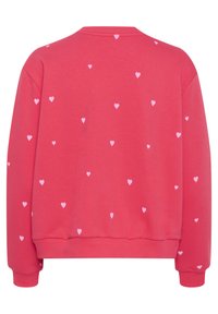 Růžová mikina s kulatým výstřihem a celoplošným vzorem malých bílých srdcí. Vyrobena z měkké tkaniny s žebrovanými manžetami a lemem.