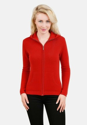 Sweat à capuche zippé rouge en tissu doux, avec des manches longues, des poches avant et une coupe slim.