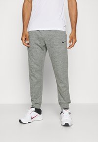 Nike Performance - PANT TAPER - Tracksuit bottoms - dark grey heather/particle grey/black Thumbnail Image 1