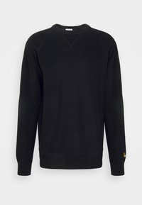 Zwart sweatshirt met ribbeltextuur, ronde halslijn en lange mouwen. Heeft een kleine gouden accent op de linker mouw.