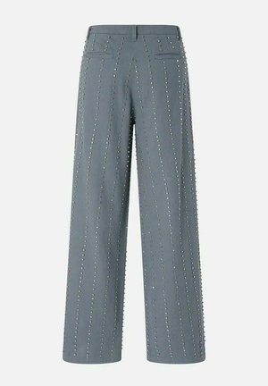 Pantaloni grigi a gamba larga con file verticali di piccoli borchiette metalliche, dotati di passanti per cintura e due tasche a filetto sul retro.