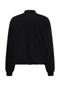 Veste noire à manches longues avec smocks élastiqués sur le haut du dos, col, poignets et taille côtelés, vue de dos.