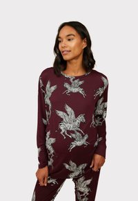 Burgundy long-sleeve top featuring a graphic design of winged zebras in white, with a round neckline and soft texture.