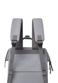 Gray backpack with padded shoulder straps, adjustable hardware, and zippers; rectangular shape with a smooth fabric texture and minimal design.