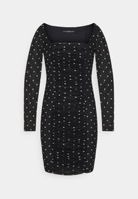 Robe noire à manches longues avec un col carré, un corps froncé et des pois blancs sur toute la surface. Tissu lisse avec une légère transparence au niveau des manches.