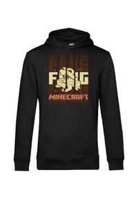 Felpa nera con un design grafico di un personaggio di gioco e testo "MINECRAFT" in basso. Il materiale sembra morbido e presenta una tasca a marsupio.