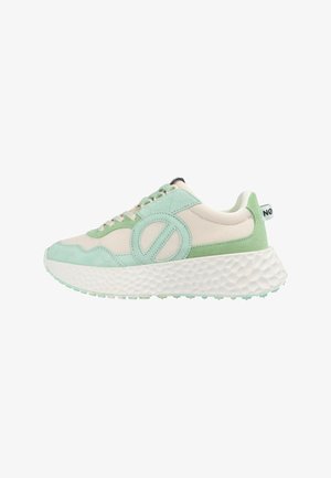Sneakers with a beige mesh upper, mint green suede accents, round logo detail, thick textured white sole, and light green outsole.