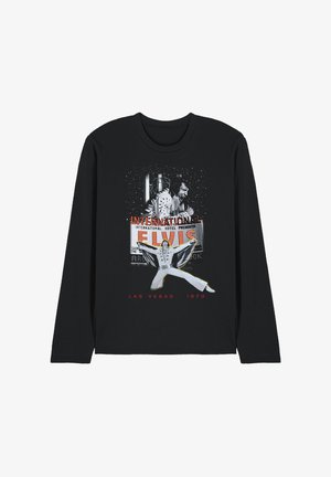 Black long-sleeve shirt with vintage Elvis Presley graphic, showing him performing in white jumpsuit, Las Vegas sign, and text "Las Vegas 1970."
