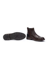 Bottes chelsea en cuir marron avec des zip latéraux, bout arrondi et semelles en caoutchouc texturé dotées d'un motif de grip.