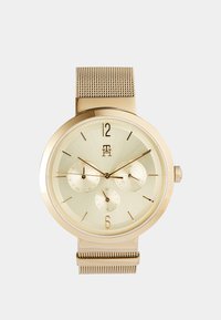 Seleccionado, gold-coloured