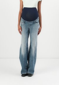 Maternity jeans with a navy stretch waistband, light wash, flared leg design, and five-pocket styling, suitable for comfort during pregnancy.