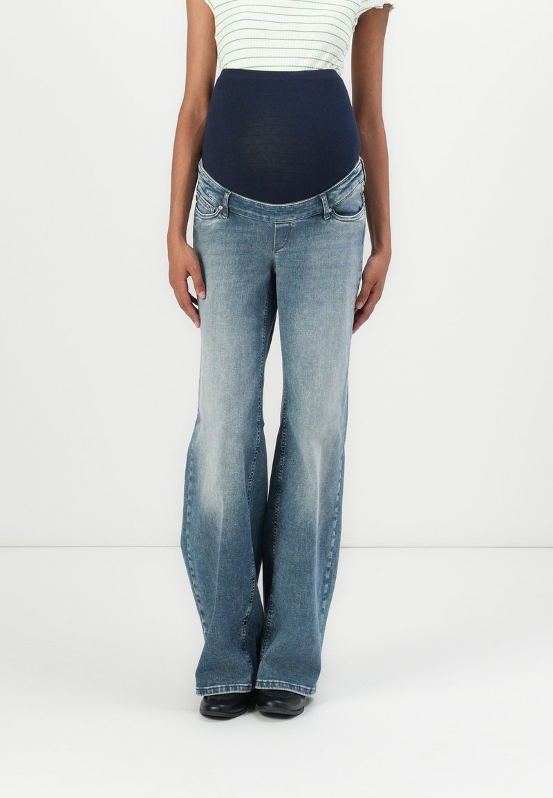 Maternity jeans with a navy stretch waistband, light wash, flared leg design, and five-pocket styling, suitable for comfort during pregnancy.