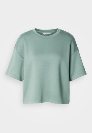 Loose-fit short-sleeve crewneck t-shirt in light teal with dropped shoulders and a plain, smooth texture.