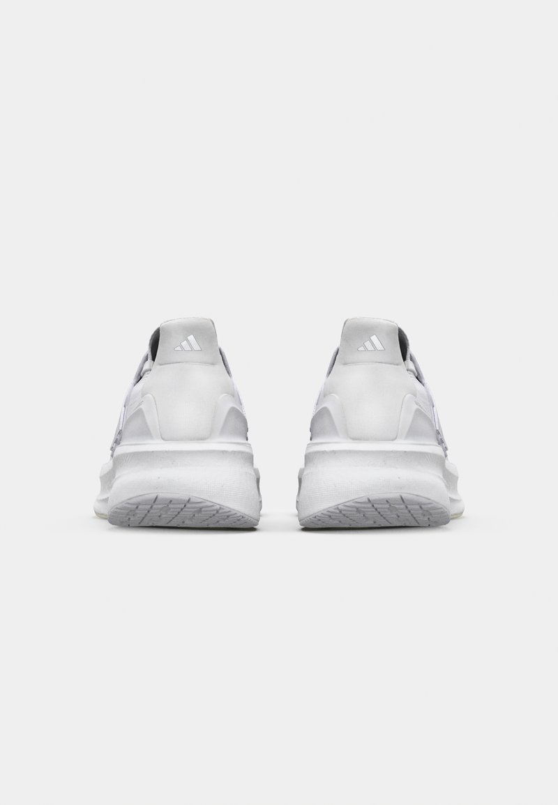 Weiße Sportschuhe mit einer strukturierten Sohle, schlankem Design und verstärktem Absatz. Mit dezenten grauen Akzenten und einem Markenlogo auf der Rückseite.
