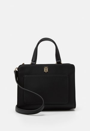 Black rectangular handbag with top handles, detachable shoulder strap, front pocket, and gold Tommy Hilfiger logo on front.