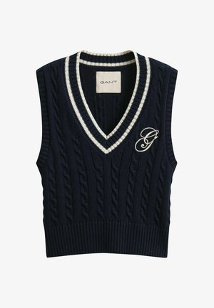Donkerblauwe kabelgebreide mouwloze trui met witte gestreepte V-hals en geborduurd "G"-logo op de linkerborst.