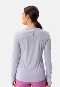 Camicia a maniche lunghe di colore viola chiaro con scollatura rotonda, caratterizzata da un accento nero sul retro e una consistenza del tessuto morbida e liscia.
