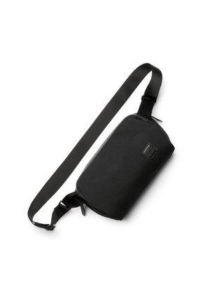 Black rectangular crossbody bag with adjustable strap and zipper closure, shown on a white background.