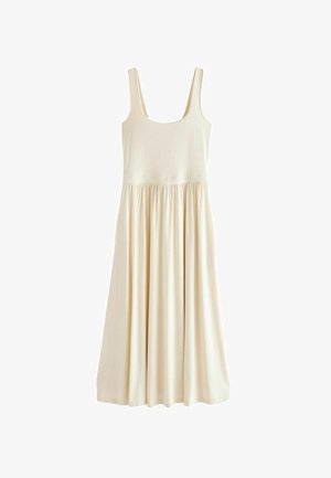 Kreminės spalvos be rankovių suknelė su apvaliu kaklu, elastinga juosmeniu ir laisvai krentančia A formos sijonu. Pagaminta iš minkštos, lengvos medžiagos.