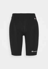 Czarne dopasowane szorty sportowe wykonane z elastycznego materiału. Na dole po lewej stronie znajduje się białe logo. Gładka tekstura, długość do kolan.