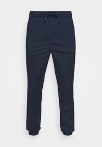 Pantaloni blu navy in cotone, dotati di una vita elastica con cordoncino, gambe affusolate e polsini a costine alla caviglia.