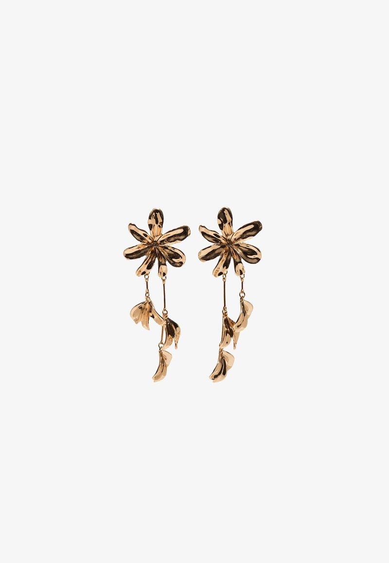 Gold-toned metal earrings shaped like flowers with six petals and two dangling, curved leaf-like elements on each earring.