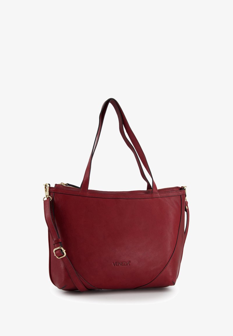 Red leather tote bag with dual shoulder straps, zippered top, and a subtle textured finish. Features a gold-tone hardware accent.