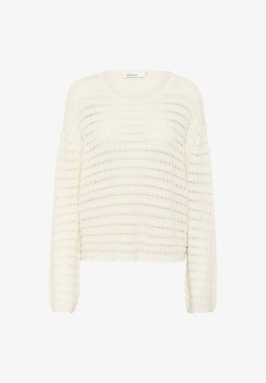 Pull en maille blanche épaisse avec une coupe ample, des manches longues et un motif en points ajourés texturé. Détail en bas de manches en forme de vagues.