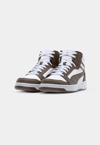 High-top sneakers in brown and white leather, featuring white laces, perforated toe box, and prominent Puma logo on the side.