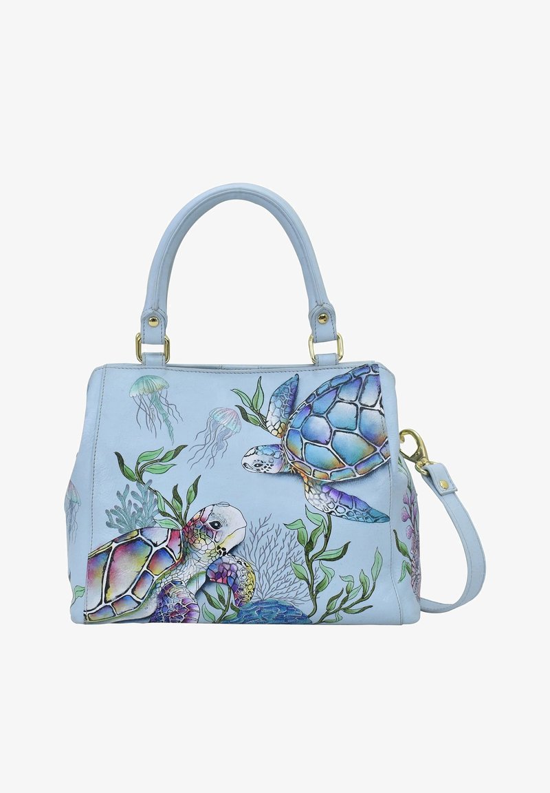 Lichtblauwe handtas van faux leer, met illustraties van schildpadden en kwal, verfraaid met groene bladeren en gouden hardware.