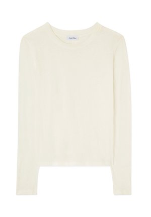 Ilgomis rankovėmis, apvalia iškirpte, smėlio spalvos marškinėliai iš lengvos medžiagos, su tiesia apačia ir mažu prekės ženklo etikete ant įvorės viduje.