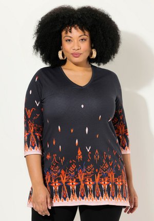 Black V-neck tunic features vibrant orange and pink floral and geometric patterns along the hem and sleeves. Soft fabric and three-quarter sleeves.