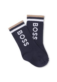 Calzini blu marino con la scritta "BOSS" in lettering bianco, dotati di un risvolto a righe beige e bianche e una texture liscia.