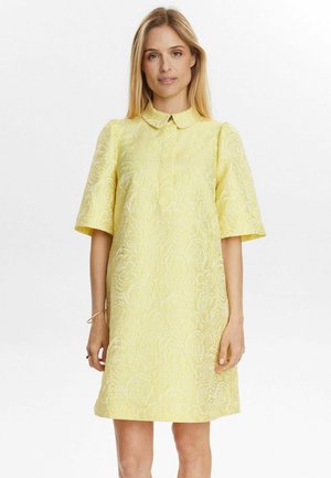 Short-sleeved yellow dress with a textured floral pattern and a collar, featuring a relaxed fit and knee-length design.