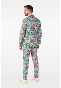 Colorful suit featuring a cartoon pattern with characters, primarily in vibrant shades of blue, pink, red, and yellow; tailored design.