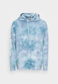 Blue tie-dye hooded sweatshirt with a front kangaroo pocket, side seams, and a white logo on the left arm. Soft, blended fabric.