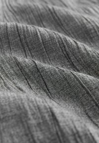 Textured gray fabric, showing soft waves and lines. The material appears smooth with varying shades of gray, emphasizing its gentle sheen.