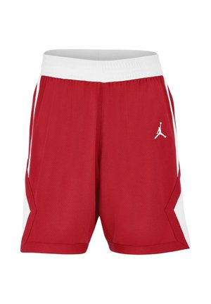 Short de basketball rouge avec taille blanche et panneaux latéraux affichant un logo Jumpman blanc sur la jambe droite.