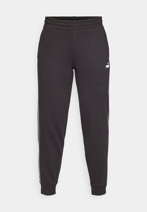 Pantaloni de trening negri cu talie elastică, manșete înguste și dungi albe pe lateral. Confecționați dintr-o țesătură moale, având un mic logo pe coapsă.