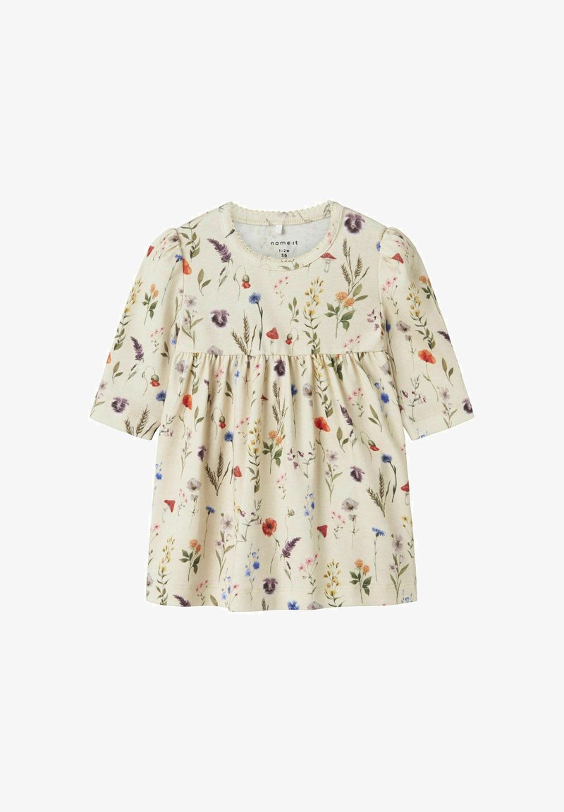 Robe beige clair à manches longues, imprimé floral dans diverses couleurs, taille froncée, encolure ronde et texture subtile.