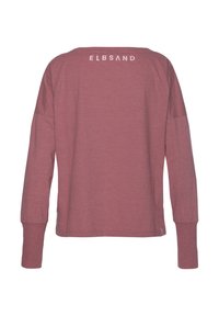 Long-sleeve shirt in muted rose color, made of soft fabric. Features a rounded neckline and the brand name printed in white on the back.