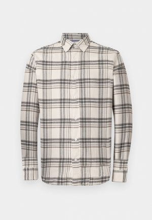 Beige színű, hosszú ujjú, gombos ing fekete és barna kockás mintával. Klasszikus gallérral és fehér gombokkal rendelkezik. Puha szövettextúra.