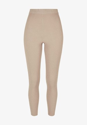 Leggings a coste di colore beige chiaro, con vita alta e design aderente, realizzati in un tessuto elasticizzato per comfort e flessibilità.