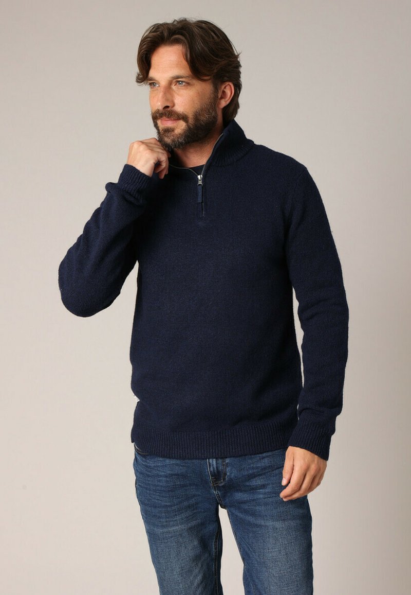 Pull-over bleu marine avec col montant et zip à mi-hauteur, fabriqué en tissu tricoté texturé. Manches ajustées et ourlet côtelé. Style décontracté.